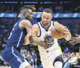  ?? ?? Warriors’ Stephen Curry (R) vies with Mavs’ Reggie Bullock, Dallas, Texas, U.S., May 22, 2022.