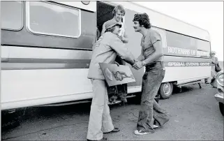  ??  ?? Garth Hogan receives the “First 200 mph trophy” from American Dale Pulde at Thunderpar­k, Hastings. Photo / Allan Porter