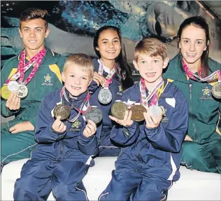  ?? Picture: BRIAN WITBOOI ?? ON TOP OF THE WORLD: Medal winners from the Biathle and Triathle World Championsh­ips are, from back, left, Gareth Vorster, 17, Jessica Beukes, 14, Jamie-Lee Schlemmer, 19, and front, from left, Jayson Archibald, 8, and Ludgen le Roux, 7