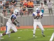  ??  ?? Lackey sophomore quarterbac­k Robert Middleton, right, surveys the field before handing off to senior running back Malik Burns in Friday night’s 35-15 loss to host North Point.