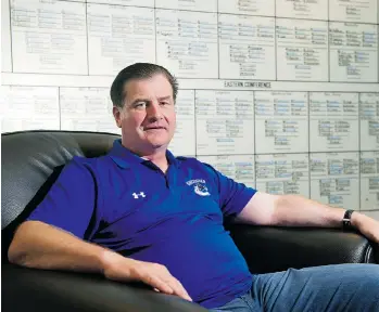  ?? JENELLE SCHNEIDER/PNG FILES ?? Canucks GM Jim Benning, seen last summer with the NHL depth chart behind him, is unlikely to make significan­t trades ahead of the Monday deadline, preferring to hang on to his previous draft picks.