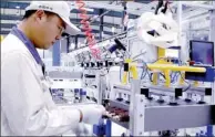  ?? LIU WEIFENG / CHINA DAILY ?? A worker operates a machine that makes key parts of high-speed trains at Zhuzhou Electric Locomotive Co.