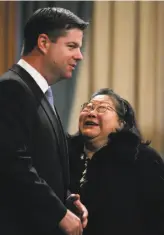  ?? Paul Chinn / The Chronicle 2011 ?? Left: Supervisor Mark Farrell speaks with Pak at a 2011 Board of Supervisor­s meeting. Pak never held elected office but wielded major political influence.