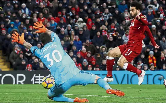  ??  ?? Talismanic figure: Liverpool’s Mohamed Salah (right) scoring the second goal in the Premier League match against Watford at Anfield on Saturday. Liverpool won 5- 0. — Reuters