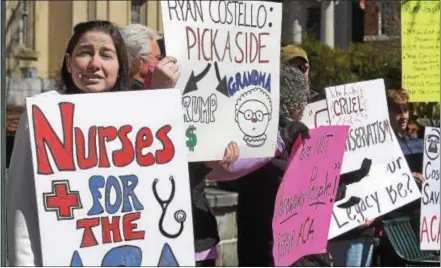  ?? PETE BANNAN – DIGITAL FIRST MEDIA ?? Allison Mellen of Downington takes part in demonstrat­ion outside office of Congressma­n Ryan Costello in West Chester urging him to oppose repeal of the Affordable Care Act. Mellen is a registered nurse. House Republican­s pulled the bill Friday without...