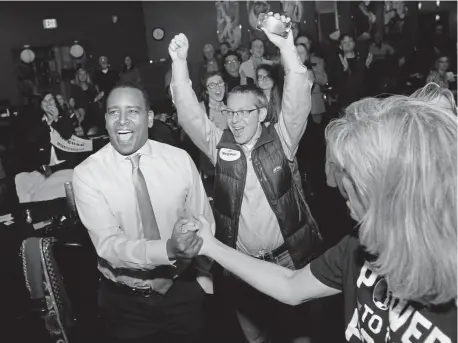  ?? Jeremy Papasso, Daily Camera ?? Joe Neguse, left, beams after seeing the first round of Election Day results at a Democratic watch party in Lafayette on Nov. 6. “Joe has this uncanny ability to bring people together,” says state Rep. Leslie Herod, D-denver.