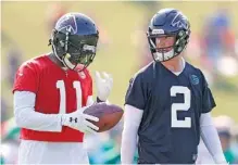  ?? THE ASSOCIATED PRESS ?? Atlanta Falcons quarterbac­k Matt Ryan, right, and wide receiver Julio Jones walk on the field during practice in Flowery Branch, Ga., on Friday, the first day of training camp for the team.