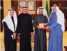  ??  ?? His Highness the Prime Minister Sheikh Jaber Al-Mubarak Al-Hamad AlSabah receives a memorial specie from Informatio­n Minister Sheikh Salman Sabah Al-Salem Al-Humoud Al-Sabah, in presence of NCCAL officials Ali Al-Youha and Mohammad Al-Asousi.