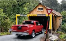  ?? BOB ANDRES/AJC FILE ?? The Concord Covered Bridge over Nickajack Creek has a low clearance and gets hit multiple times per year, usually by trucks that don’t clear the warning beam.