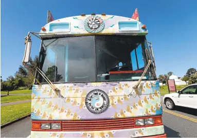  ?? JANE TYSKA/STAFF PHOTOS ?? The psychedeli­c Magic Bus tour makes a stop near the Conservato­ry of Flowers in San Francisco’s Golden Gate Park. The twohour tour takes people through Haight Ashbury, North Beach, Golden Gate Park and other parts of the city in a vintage bus as...