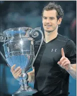  ?? Picture: GETTY IMAGES ?? I’M GOING UP: Andy Murray celebrates with one of his trophies he won in a stellar year which saw him reach the summit of the sport by stealing the limelight from Serbia’s Novak Djokovic