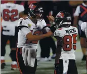  ?? MARK LOMOGLIO — THE ASSOCIATED PRESS ?? Bucs QB Tom Brady, left, celebrates with wide receiver Jaydon Mickens during Sunday’s win over the Packers.