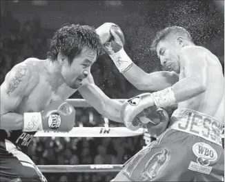  ?? Isaac Brekken Associated Press ?? MANNY PACQUIAO, left, lands a left against Jessie Vargas on the way to a victory.