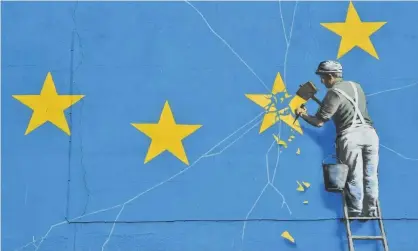  ?? Photograph: Glyn Kirk/ AFP/Getty Images ?? A mural by British artist Banksy depicting a worker chipping away at one of the stars on a European Union flag.