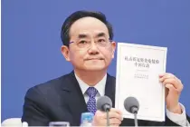  ?? AP PHOTO ?? WHITE PAPER
Xu Lin, Vice head of the Publicity Department of Communist Party shows a copy of the white paper on fighting Covid-19 during a press conference at the State Council Informatio­n Office in Beijing, Sunday, June 7, 2020.