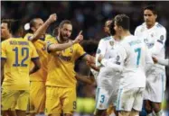  ?? THE ASSOCIATED PRESS ?? Real Madrid’s Cristiano Ronaldo argues with Juventus’ Gonzalo Higuain during a Champions League quarter final second leg soccer match between Real Madrid and Juventus at the Santiago Bernabeu stadium in Madrid, Wednesday.