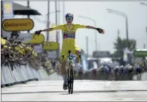  ?? DANIEL COLE — THE ASSOCIATED PRESS ?? Belgium’s Wout Van Aert, wearing the overall leader’s yellow jersey celebrates as he crosses the finish line to win the fourth stage of the Tour de France on Tuesday.