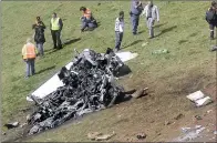  ??  ?? IN PIECES: A propeller, two wheels and part of a wing structure visible after the plane practicall­y disintegra­ted on impact. It was misty and windy at the time of the crash, a farmer who lives nearby, said of the weather conditions.