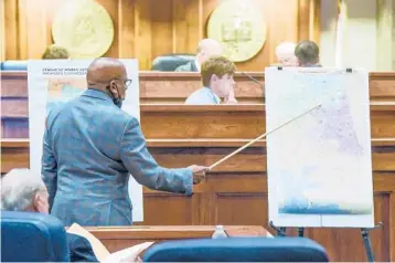  ?? MICKEY WELSH/THE MONTGOMERY ADVERTISER ?? State Sen. Rodger Smitherman compares district maps during a special session about redistrict­ing on Nov. 3 at the Alabama Statehouse in Montgomery.