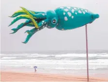  ??  ?? The wind blows an inflatable sculpture at Surfers Paradise.