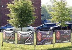  ?? STAFF PHOTO BY C.B. SCHMELTER ?? Drivers wait in line for COVID-19 testing at Brainerd High School on Monday.