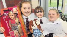  ??  ?? Donations Attraction­s like this ‘guess the doll’s name’ helped the school raise £500