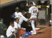  ?? NHAT V. MEYER — BAY AREA NEWS GROUP, FILE ?? A’s starting pitcher Jesus Luzardo (41) is welcomed to the dugout by Mark Kotsay (3) during Game 1 of their American League wild-card playoff series against the White Sox on Sept. 29 at the Coliseum in Oakland.