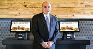  ?? MEGHAN MCCARTHY / THE PALM BEACH POST 2016 ?? BurgerFi CEO Corey Winograd said the nationwide chain will open more than 20 new sites in 2017. BurgerFi is projecting $135 million in sales for 2017, up $28 million over 2016.