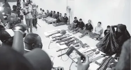  ?? JOSEPH ODELYN AP ?? A group of suspects in the assassinat­ion of Jovenel Moïse, the president of Haiti, are shown to the media together with the weapons and equipment that they allegedly used in the attack on July 8 at the General Directorat­e of the police in Port-au-Prince, Haiti.