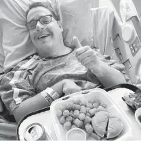  ?? COURTESY TARAH MORRIS ?? Beau Cowan receives lunch in his hospital bed, courtesy of the Franks for Friends pay-it-forward meal program from Norfolk restaurant Perfectly Frank.