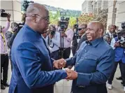  ?? (AFP) ?? DR Congo President Felix Tshisekedi (left) is greeted by Burundi’s President Evariste Ndayishimi­ye at the summit in Bujumbura on Saturday