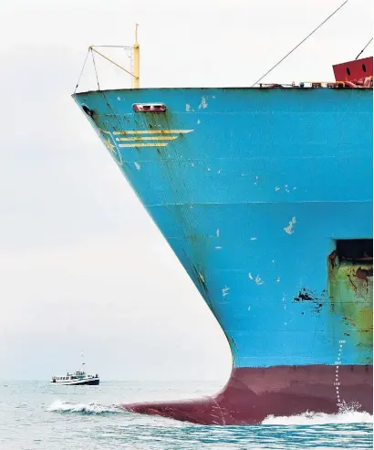  ?? PHOTO: STEPHEN JAQUIERY ?? Upgrade . . . Maersk container ships such as Maersk Brani, pictured, will be replaced by Rioclass vessels which are 21m longer at 286m. In the background is the tourist boat Monarch, at the entrance to the Otago Harbour.