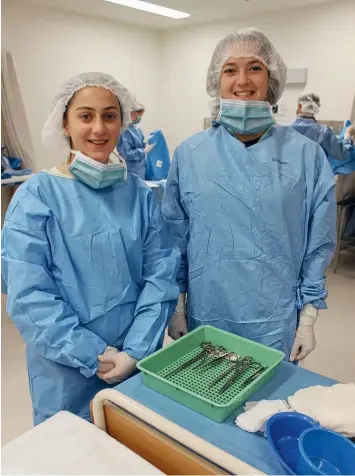  ??  ?? SCRUBBED UP: Sacred Heart students Ebony and Alyssa in the simulated theatre.