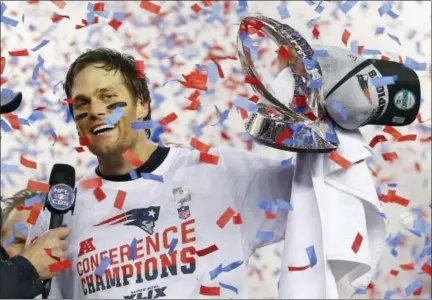  ?? JULIO CORTEZ — THE ASSOCIATED PRESS FILE ?? In this file photo, New England Patriots quarterbac­k Tom Brady holds up the championsh­ip trophy after the NFL football AFC Championsh­ip game against the Indianapol­is Colts, in Foxborough, Mass.