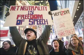  ?? Ap photo ?? Demonstrat­ors rally in support of net neutrality outside a Verizon store in New York.