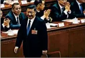  ?? ANDY WONG/AP ?? President Xi Jinping walks to his seat Sunday after casting his vote for an amendment to the Chinese Constituti­on.