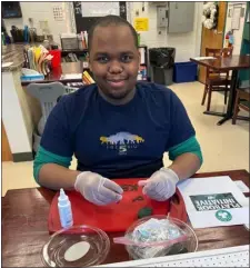  ?? COURTESY LITTLETON PUBLIC SCHOOLS ?? Kyle Musomba, a participan­t in Littleton’s PACE program, uses his passion for baking and cake decorating to make a specialty cake for members of Littleton Middle School’s Playbook Initiative.