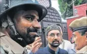  ??  ?? Separatist leader Mirwaiz Umar Farooq being detained by police outside his residence in Srinagar on Monday. WASEEM ANDRABI/HT