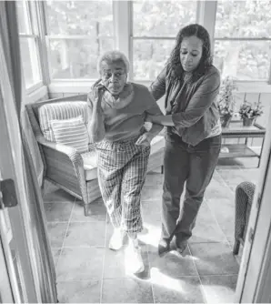  ?? MICHAEL A. SCHWARZ, USA TODAY ?? Karen Thomas, CEO and managing partner of Labor of Love Adult Care, assists her mother, Willeane Romaine, 83, at Labor of Love Adult Care in Flowery Branch, Ga.