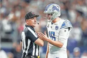  ?? JUNFU HAN/DETROIT FREE PRESS ?? Lions quarterbac­k Jared Goff talks to a referee regarding offensive tackle Taylor Decker’s two-point conversion catch against the Cowboys being called illegal touching on Saturday.