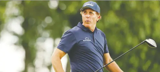  ?? Maddie Meyer/getty images ?? Phil Mickelson reacts to his shot on the 18th tee during the second round of the Travelers Championsh­ip on Friday. He’s at a 13-under 127 at the midway point.