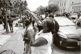  ?? Lea Suzuki / San Francisco Chronicle ?? Catherine London, a Lyft driver, cheers with others while listening to speakers during a driver protest.