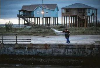  ?? Jon Shapley / Staff photograph­er ?? Jaime Galdamez fishes Friday at Roll Over Pass in Gilchrist on the Bolivar Peninsula.