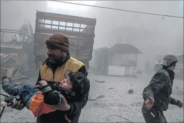  ?? Mohammed Badra EPA/Shuttersto­ck ?? A VOLUNTEER carries a boy wounded by bombing in the Syrian rebel-held enclave of eastern Ghouta.