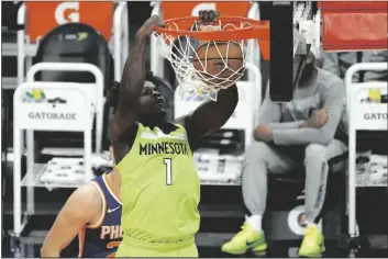  ?? RICK SCUTERI – AP ?? MINNESOTA TIMBERWOLV­ES FORWARD Anthony Edwards (1) dunks against the Phoenix Suns during the first half of an NBA basketball game Thursday in Phoenix.