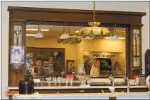  ?? Mona Weatherly ?? Above is the antique cabinet and mirror that the new cabinet for the mural was designed to match. In the mirror on the left, Tammy Hendrickso­n and Clay Mohr can be seen. See next week’s Chief for the second part on the Talbot mural coming to Broken Bow.