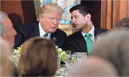  ?? EVAN VUCCI/AP ?? President Donald Trump talks Thursday with House Speaker Paul Ryan on Capitol Hill. Ryan, R-Wis., threw cold water on Trump’s theory about wiretappin­g, telling reporters: “We’ve cleared that up; we’ve seen no evidence of that.”