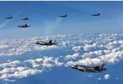 ?? South Korean Defense Ministry via New York Times ?? South Korean F-15K fighter jets and American F-35B stealth jet fighters fly over South Korea during a joint military drill Thursday.