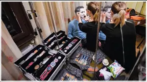  ?? ?? Viorel, a Romanian inmate, gets his makeup applied before performing in “State of Siege”.