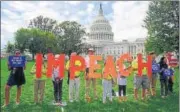  ?? AFP ?? Protesters hold up letters reading ‘impeach’ in front of the parliament building in US Capitol, Washington DC.